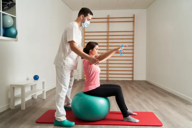 Modern Movement Medicine clinic: healthcare professional assisting patient with IV therapy and exercise.