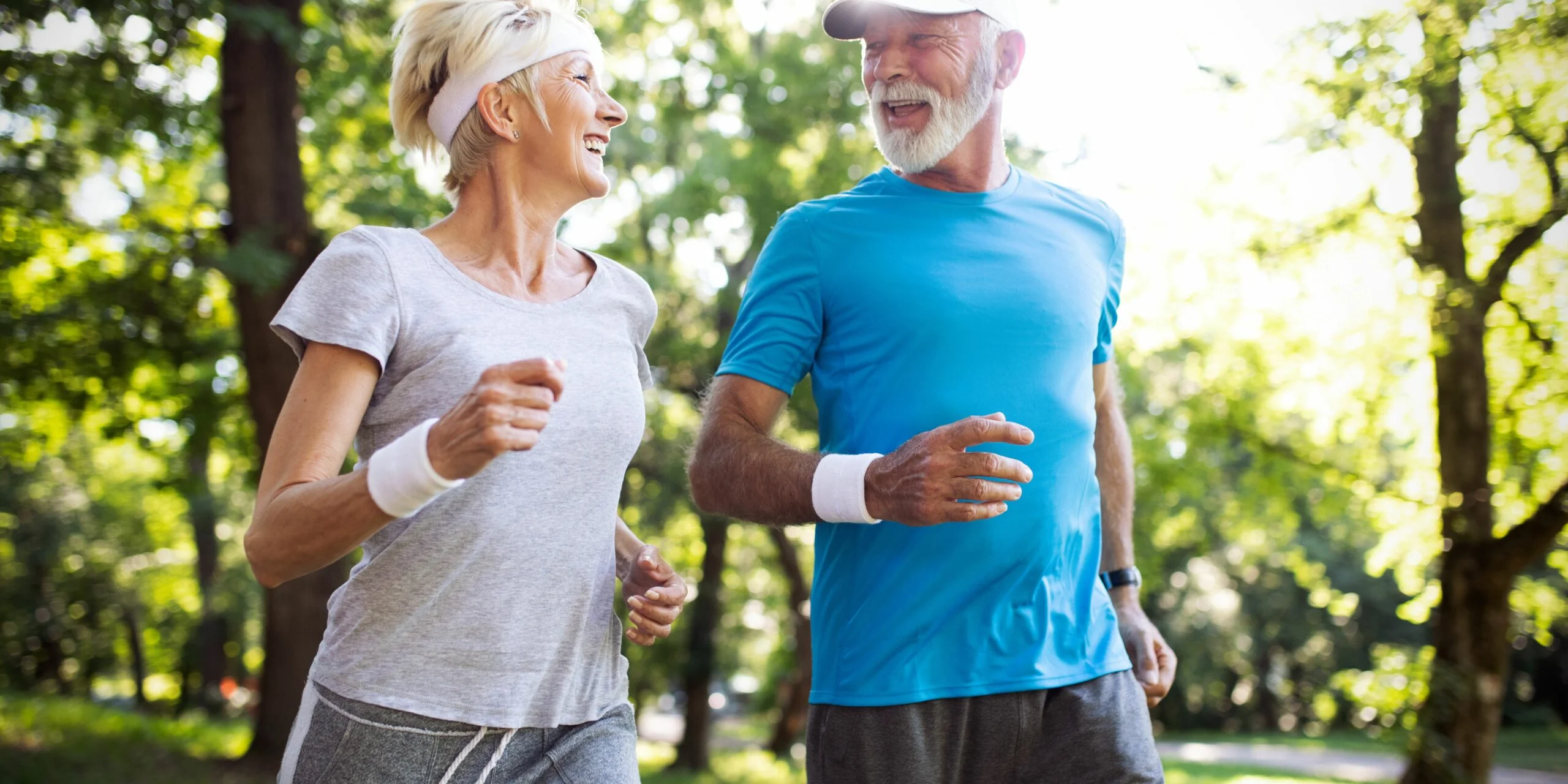 Active older couple enjoying exercise and movement outdoors.