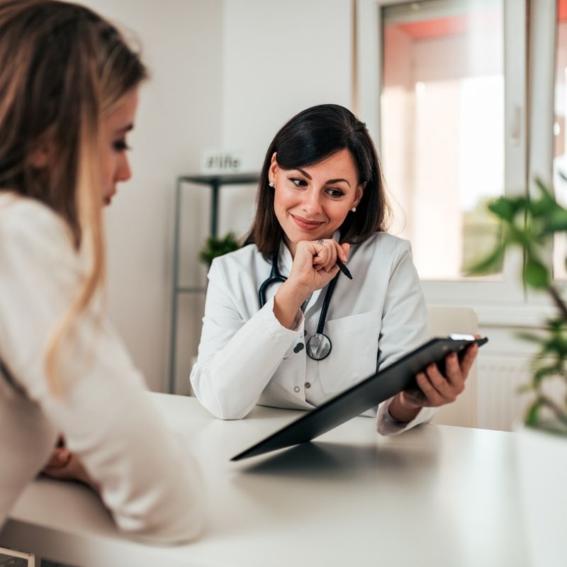 Doctor and patient consultation at Modern Movement Medicine for pain relief and wellness.