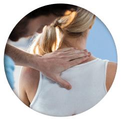 Chiropractor performing motion palpation on patient's spine for subluxation assessment.