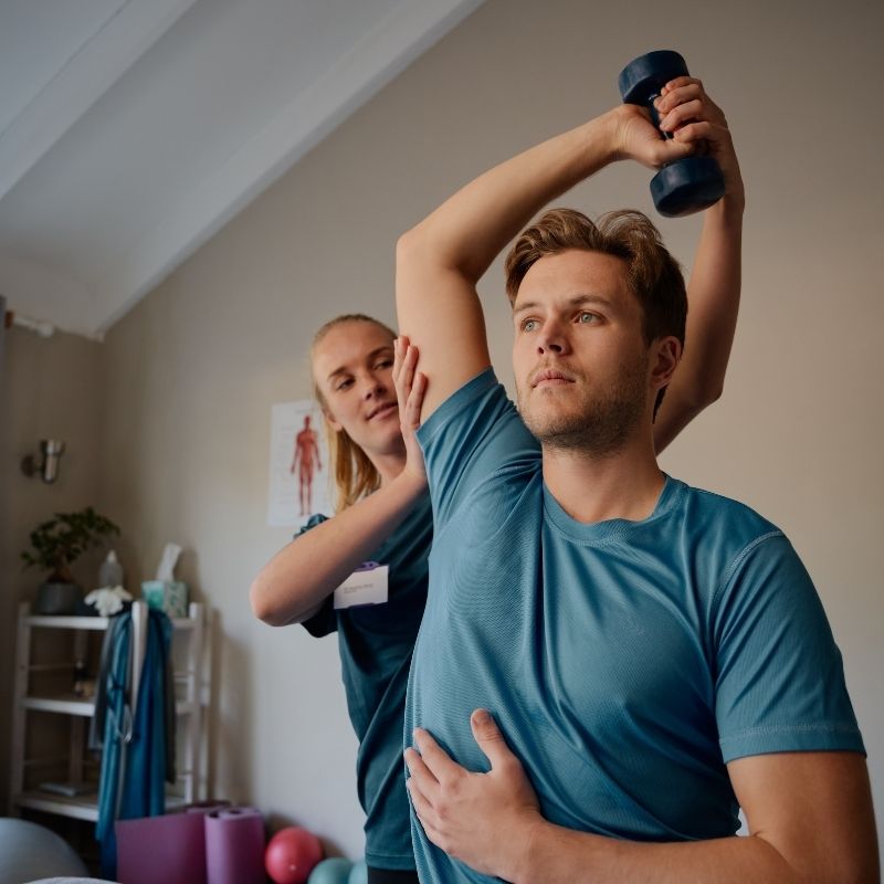Man performing exercise with dumbbell, functional assessment in progress.