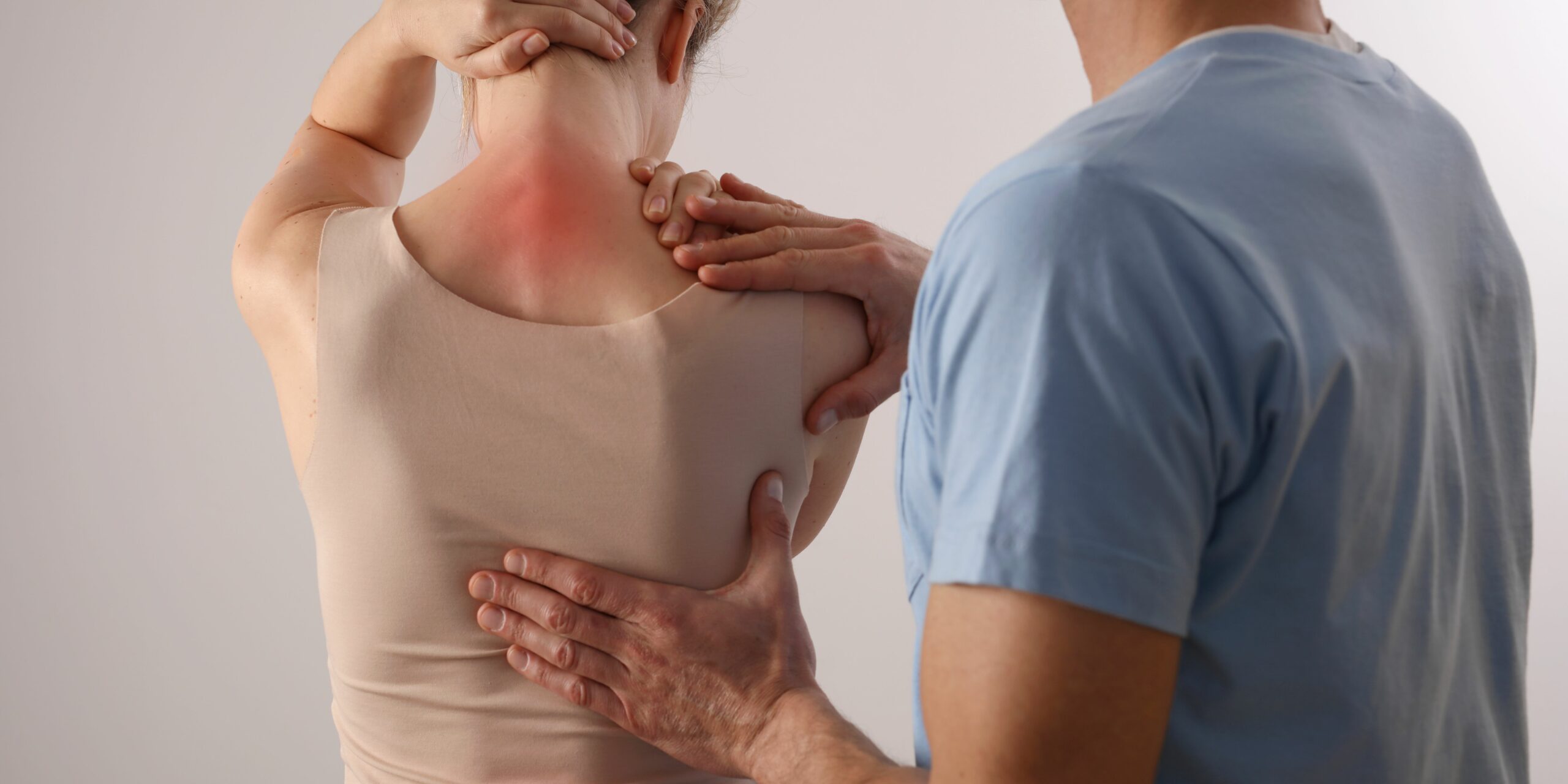 Woman experiencing neck and back pain receiving treatment and care.