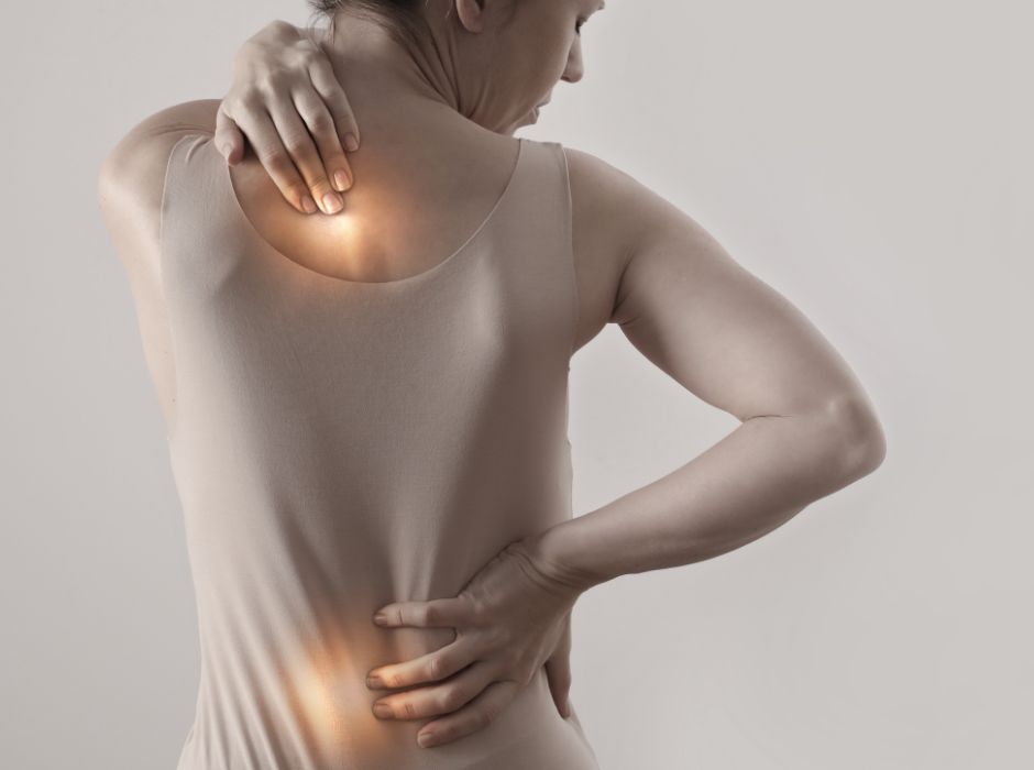 Woman experiencing back pain and discomfort, Modern Movement Medicine treatment.