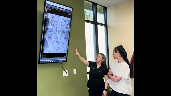 Dr. Brittany Brockman discussing x-rays with a patient