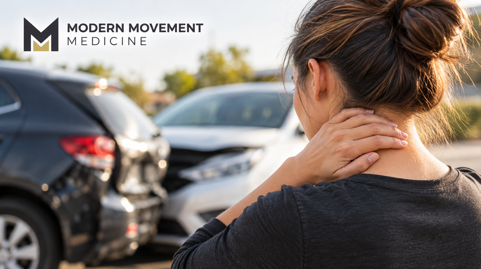 Woman touching her neck with two cars involved in a collision in the background, illustrating